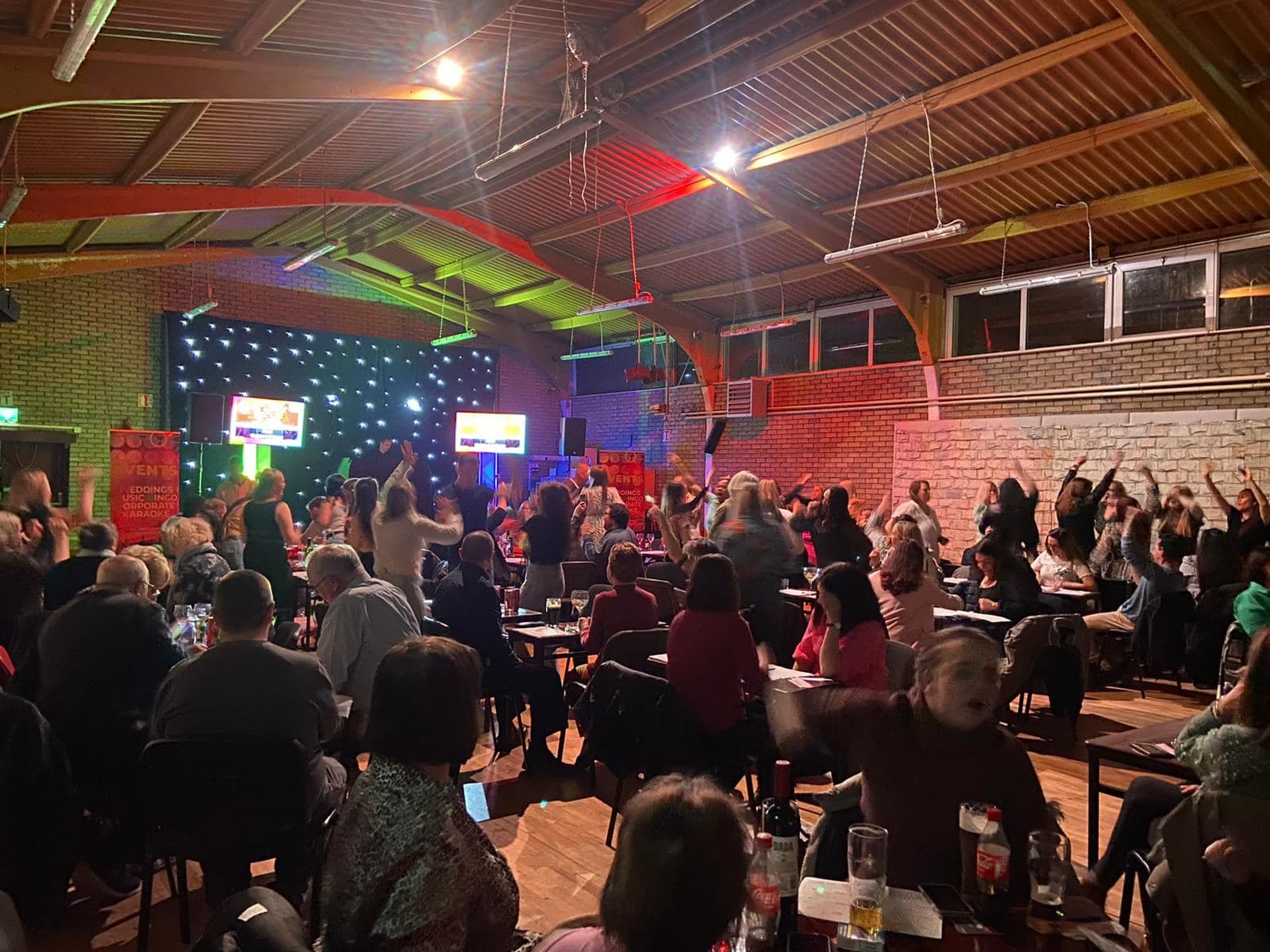 A full hall playing Music Bingo with DJ Alan