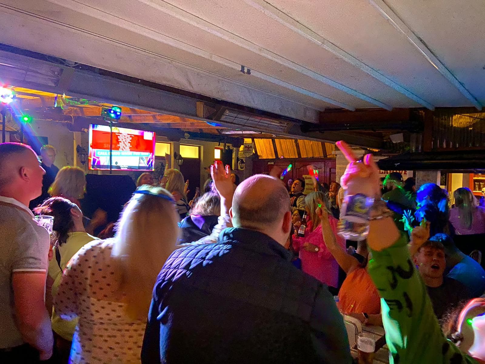 Hands in the air at a Music Bingo night